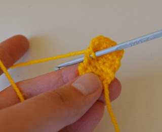 Crochet evenly down the side of the rows making 5 sc